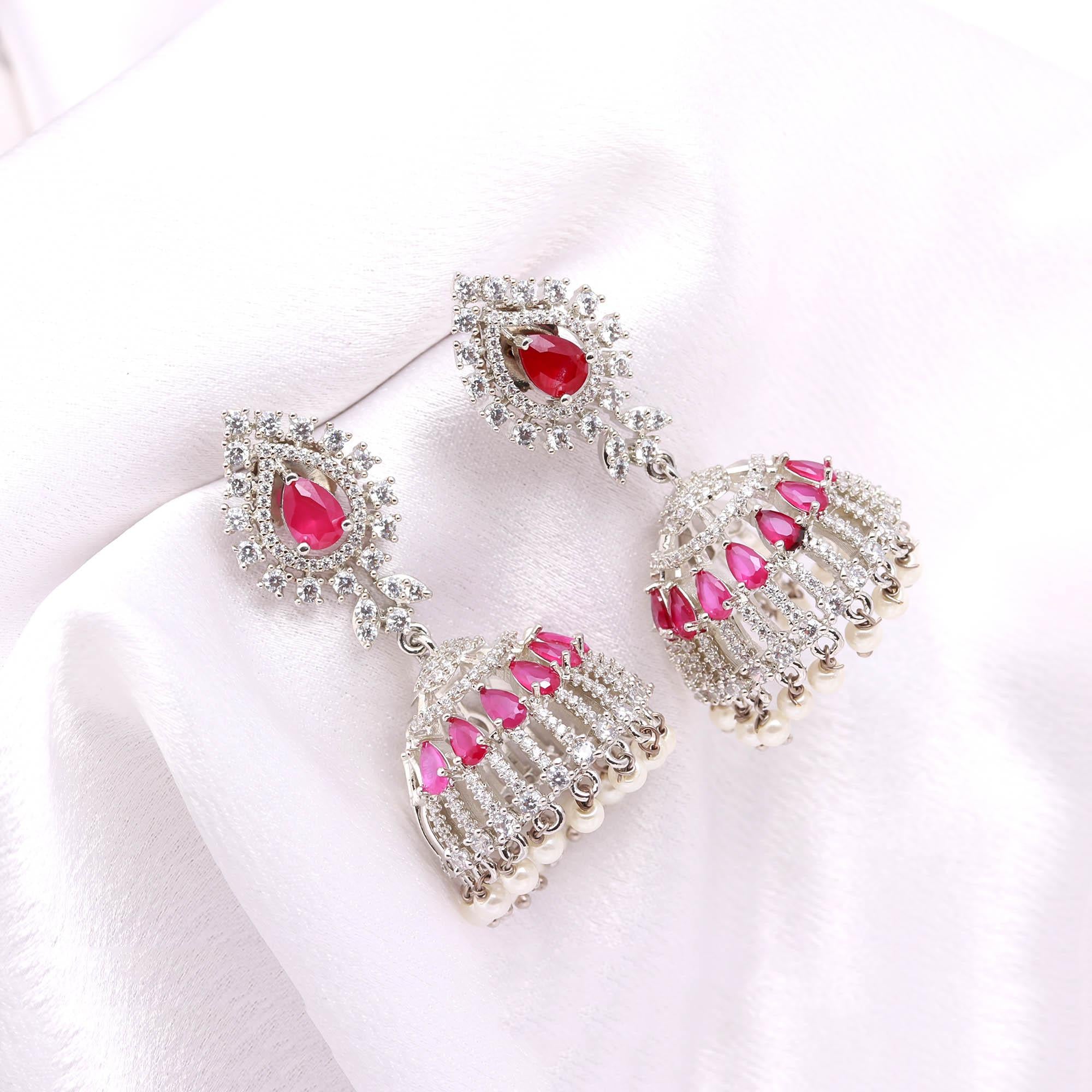 Exquisite Ruby Red American Diamond (AD) Jhumka Earrings with Pearl Drops | Silver Toned Party Wear - Haamsi