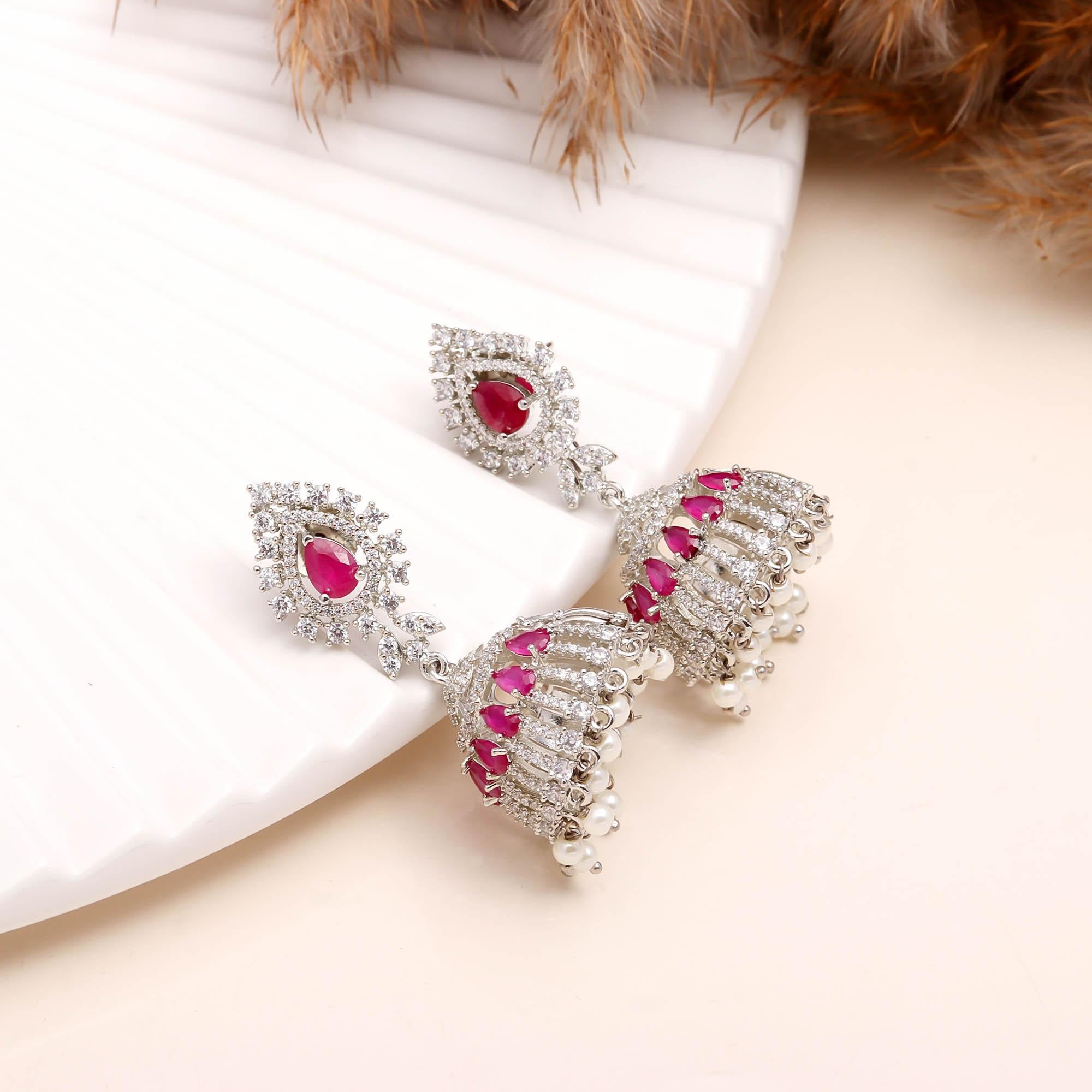 Exquisite Ruby Red American Diamond (AD) Jhumka Earrings with Pearl Drops | Silver Toned Party Wear