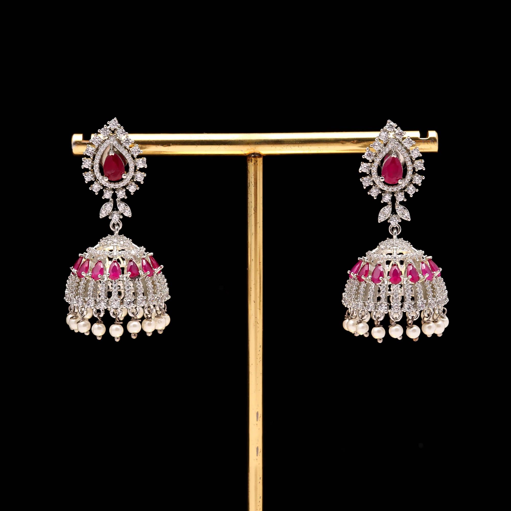 Exquisite Ruby Red American Diamond (AD) Jhumka Earrings with Pearl Drops | Silver Toned Party Wear - Haamsi